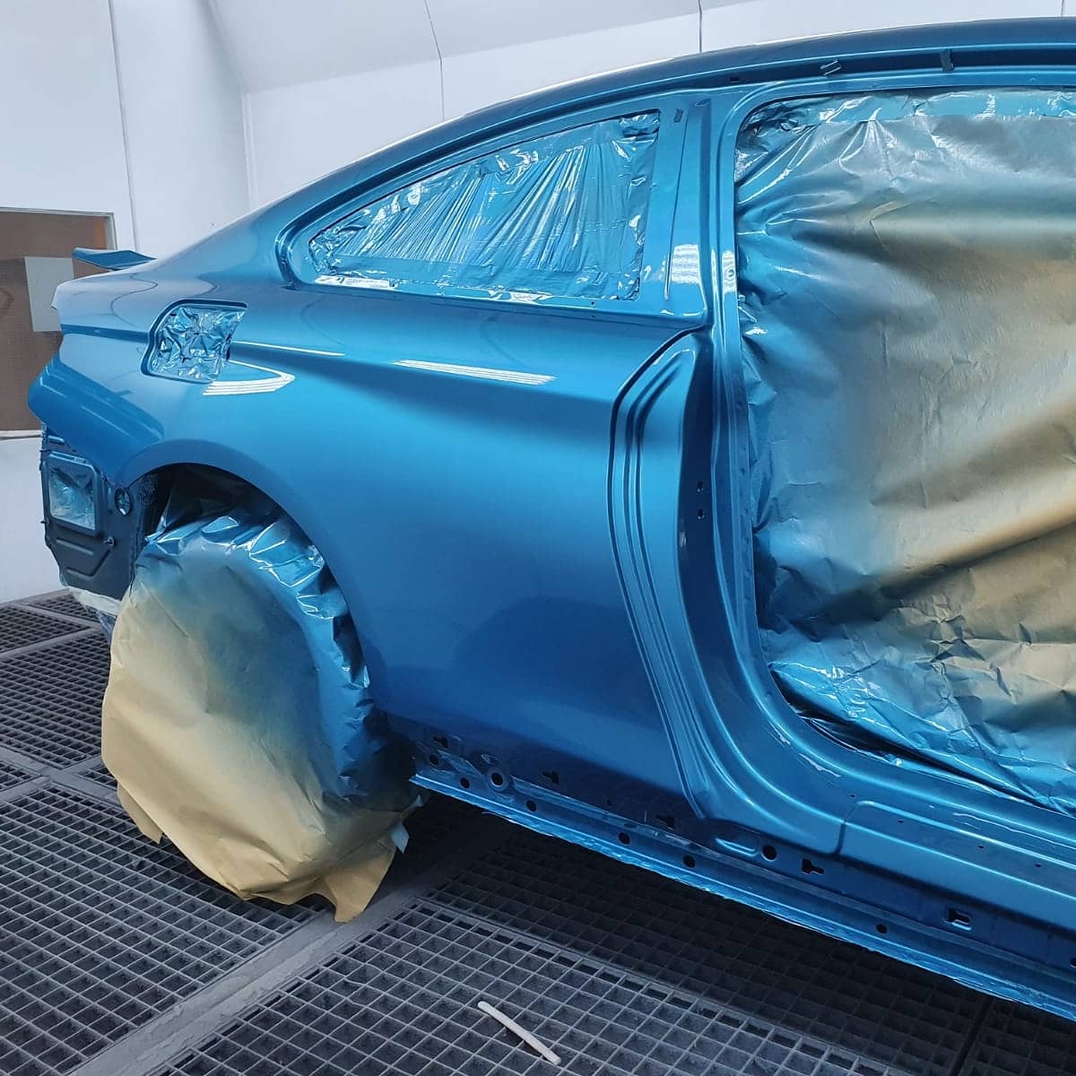 Blue BMW in paint shop.